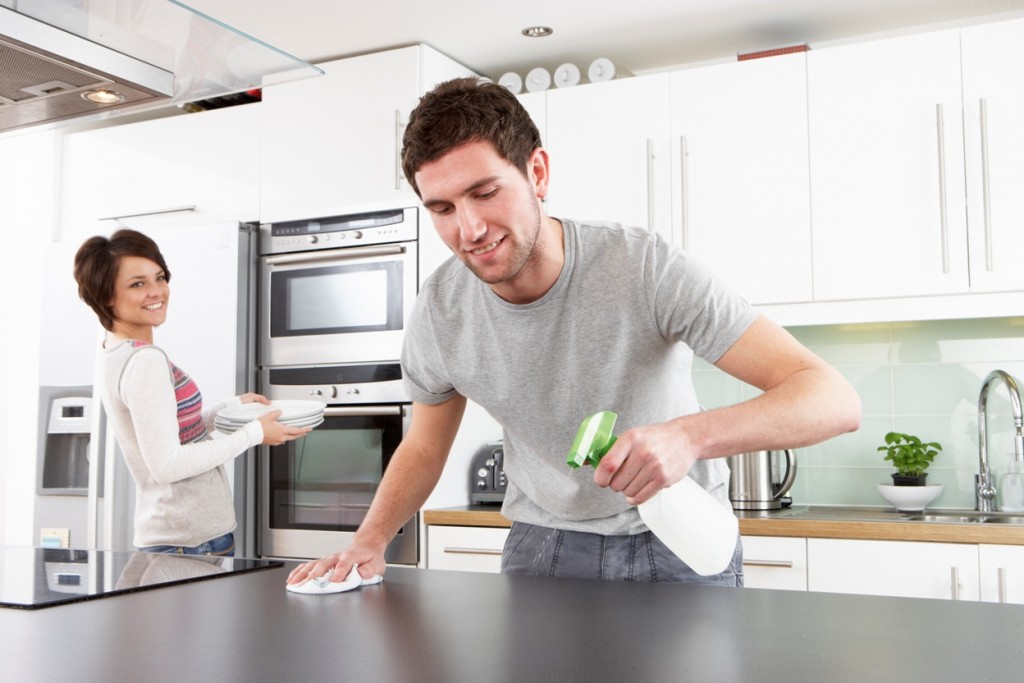 Young Couple Cleaning Kitchen