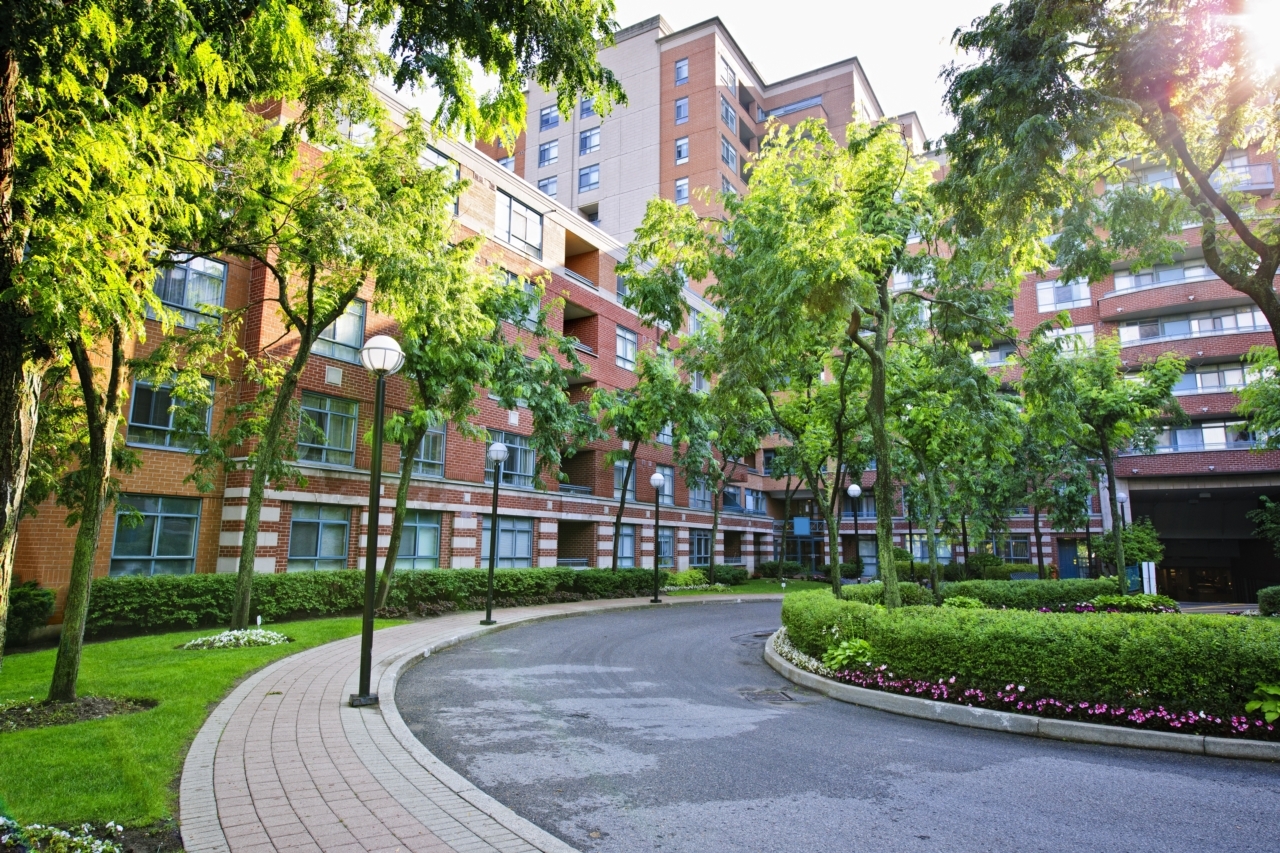 15391773 – circular driveway and sidewalk at brick condominium building