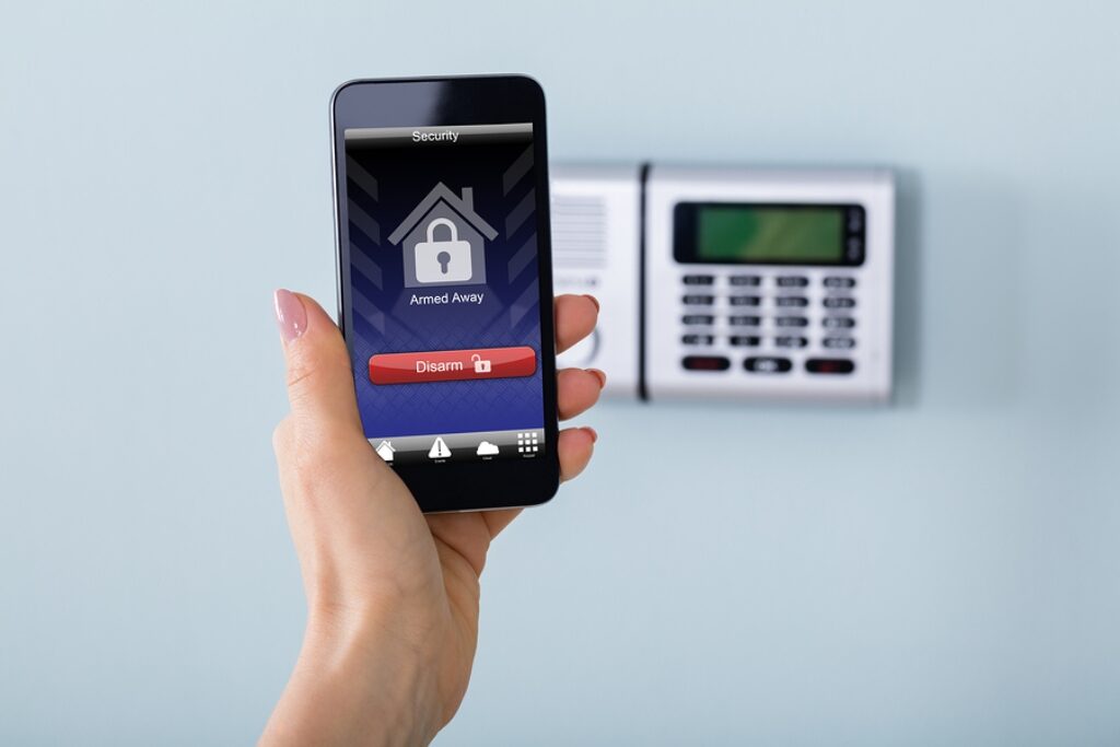 Security Alarm Keypad With Person Disarming The System With Remote Controller