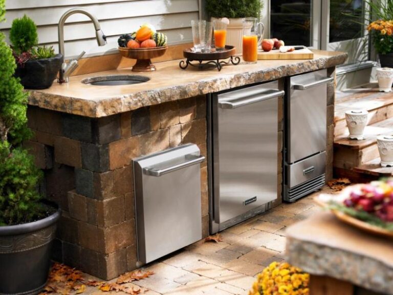 outdoor kitchen with refrigerator and sink