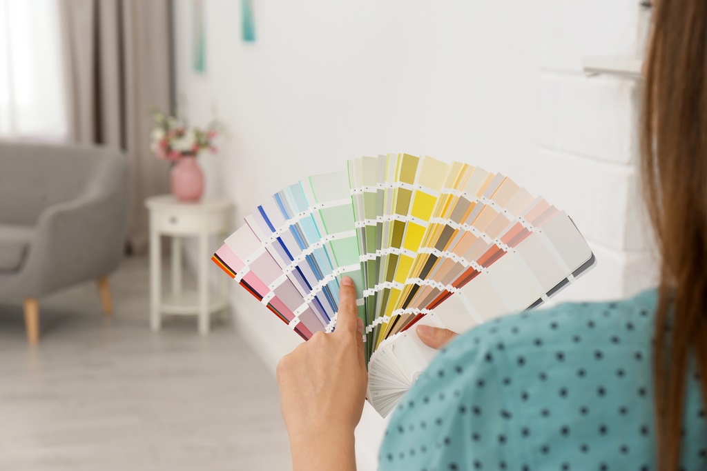 Female interior designer with color palette samples indoors