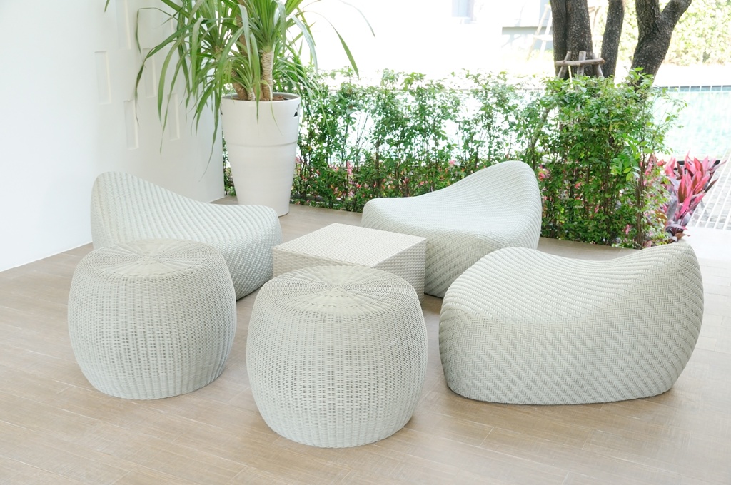 Luxury rattan sofa set with green plant in opening dining room