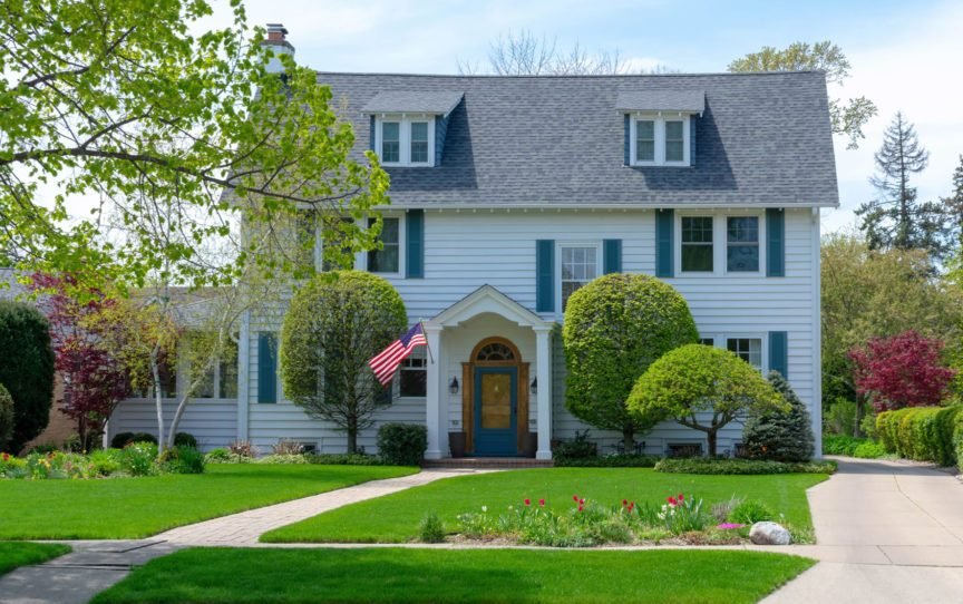 Front view of traditional colonial home with blue shutters