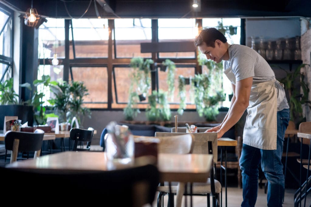 Waiter cleaning up at a restaurant