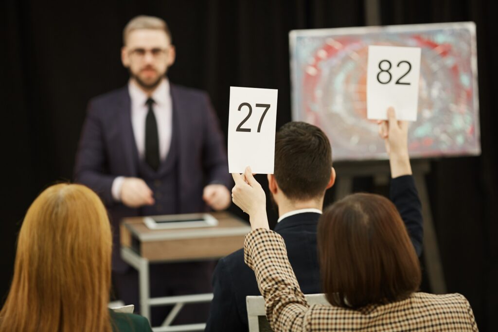 People with signs at auction