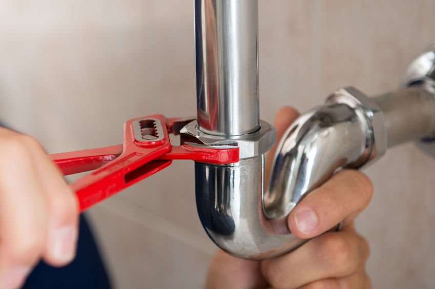 33251412 – closeup of plumber fixing pipe with wrench