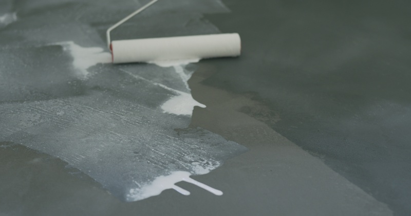 closeup applying sealant on the concrete floor