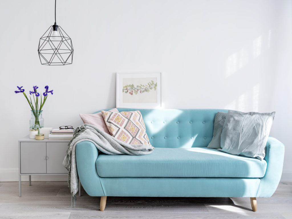 Bright blue sofa in stylish home interior