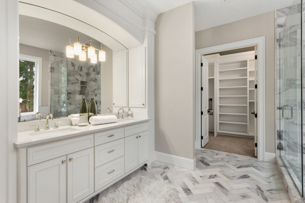 Master bathroom in new luxury home with double vanity and view o