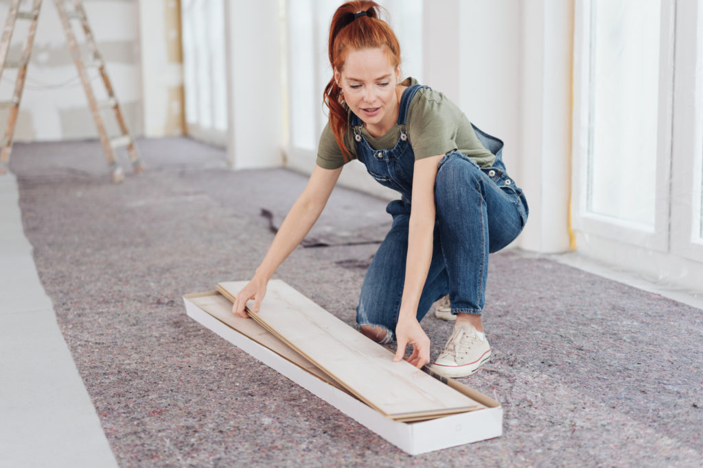 Young woman removing paneling boards