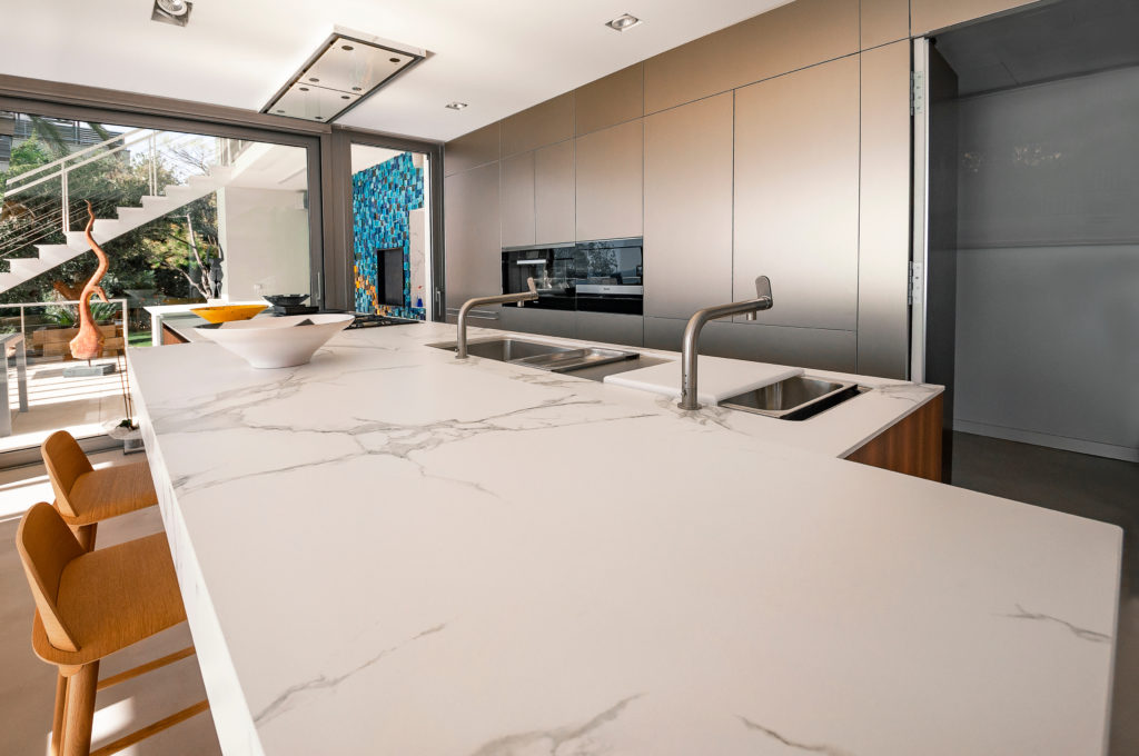 Luxury modern kitchen with marble worktop, modern kitchen sink.
