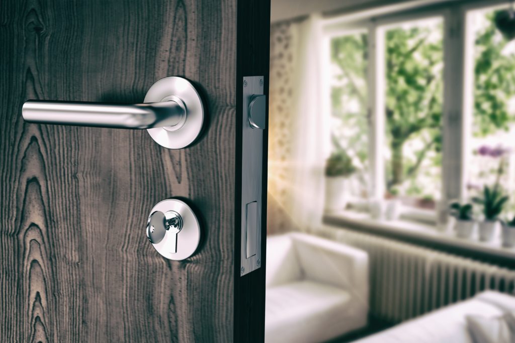 Composite image of brown door with metal doorknob and lock