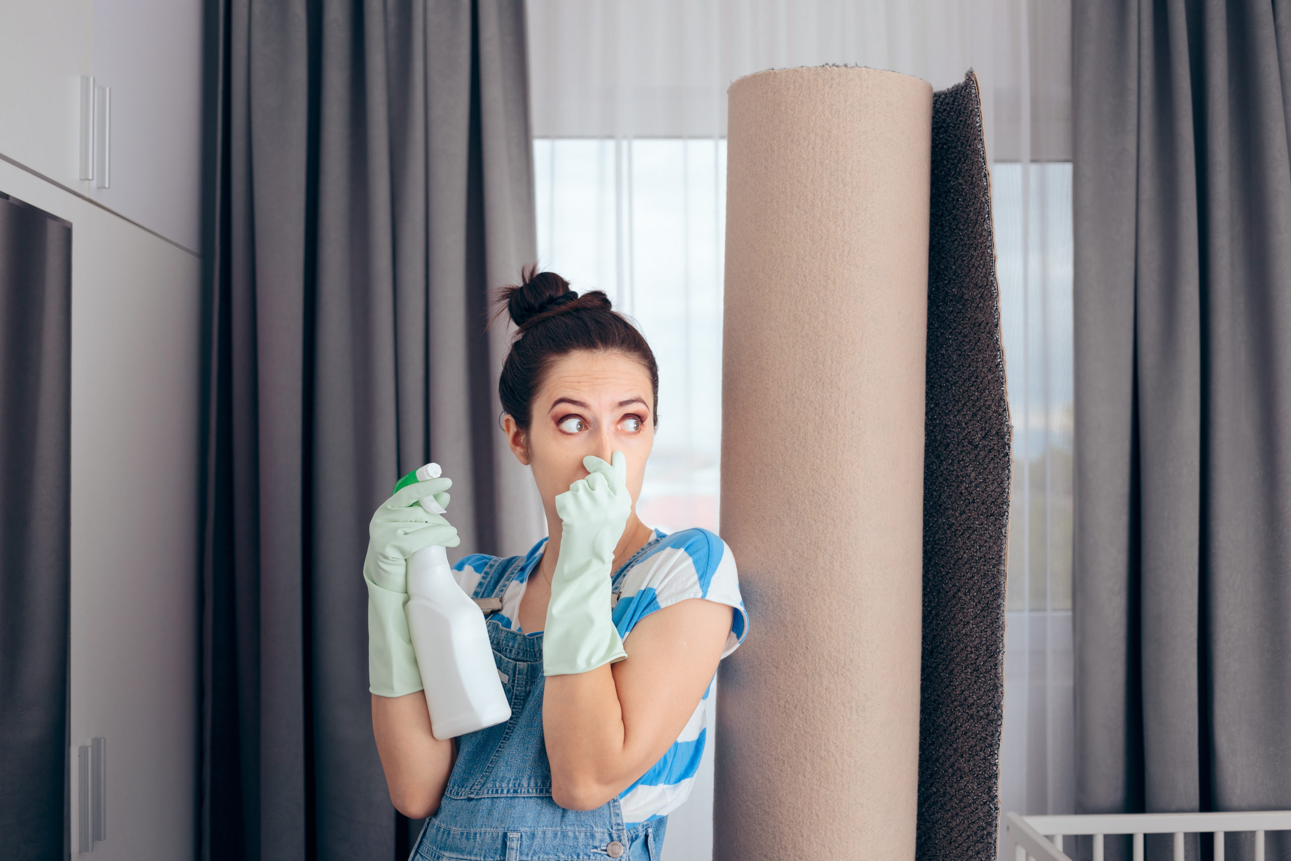 Woman Next to a Stinky Carpet Covering Her Nose