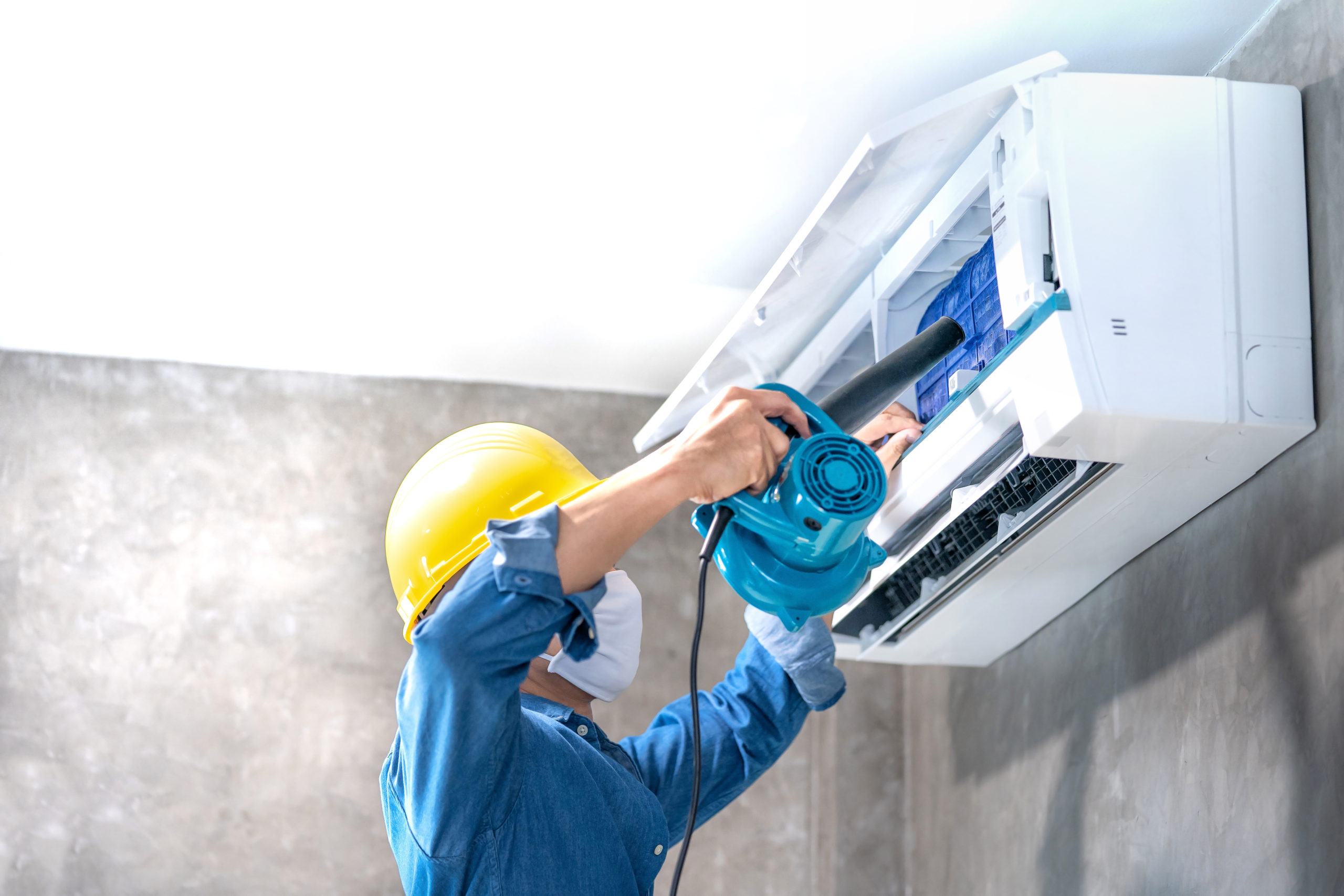 Technician man repairing ,cleaning and maintenance Air condition