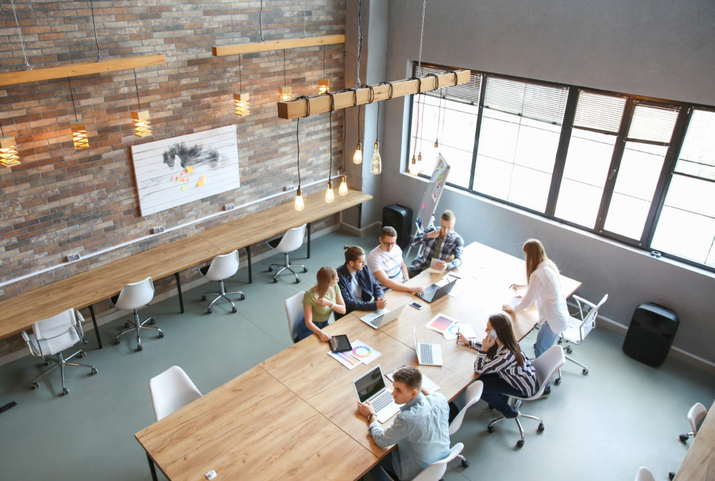 Young people having business meeting in modern office