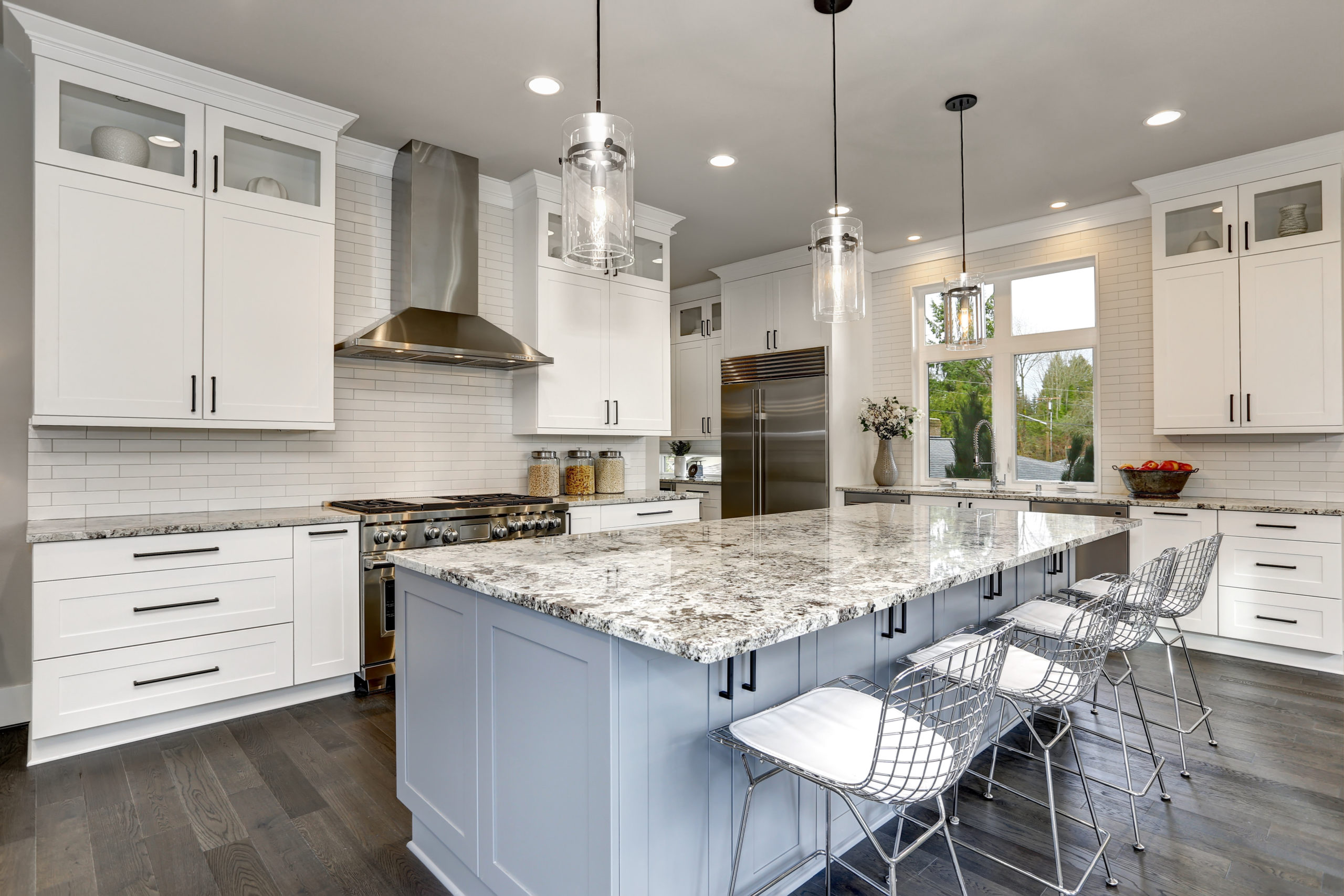 Beautiful kitchen in luxury home interior with island and stainl