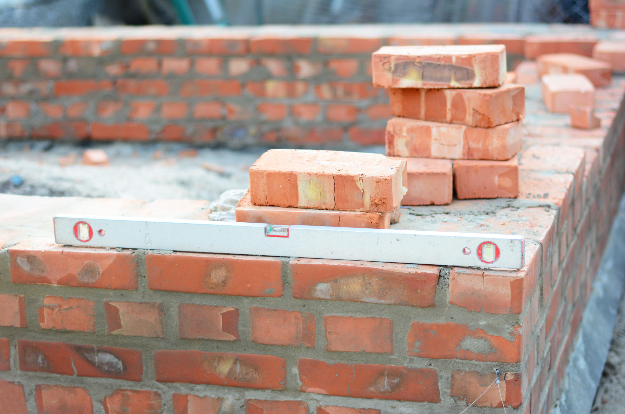 Building a brick foundation wall corner of a house construction