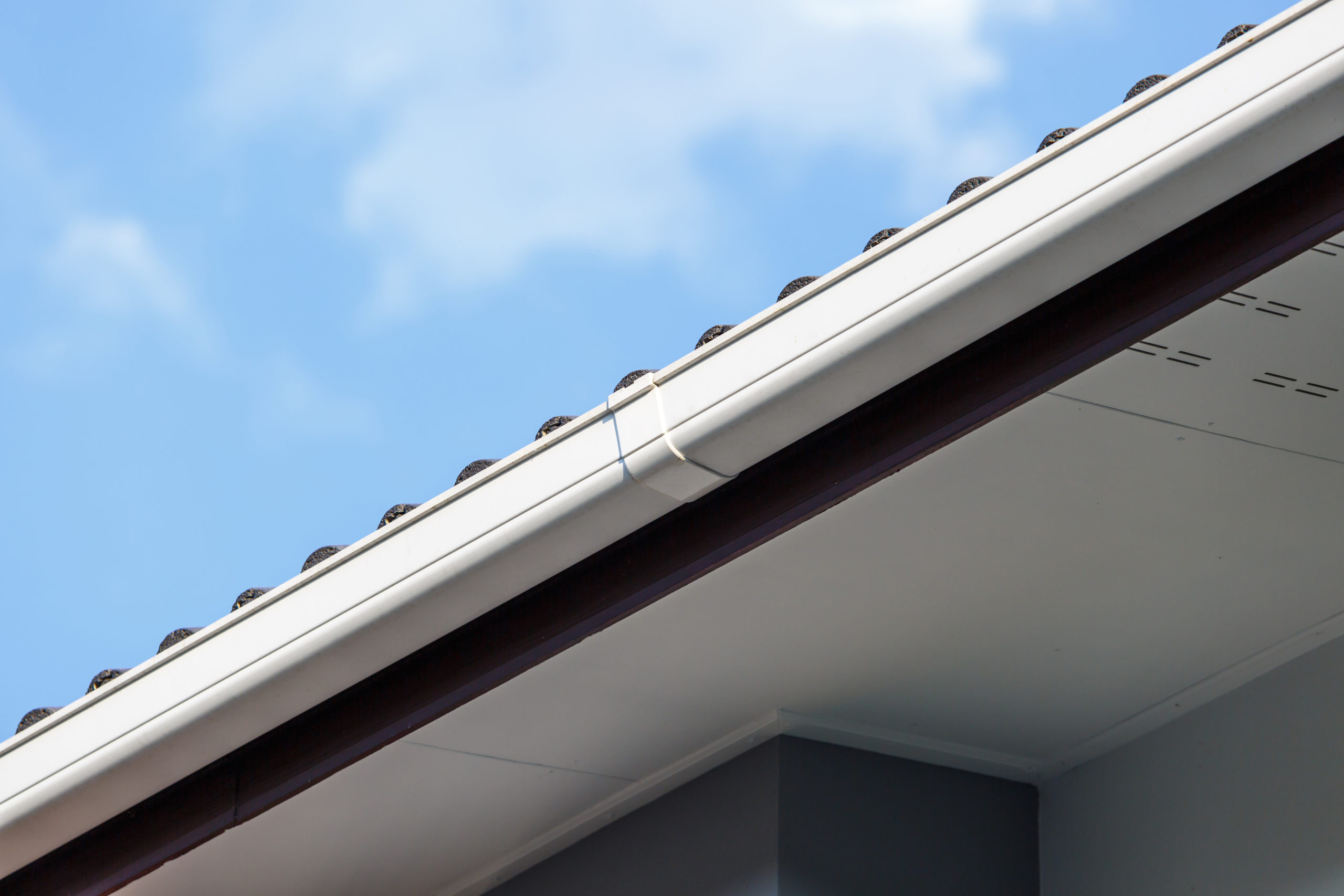 White gutter on the roof top of house