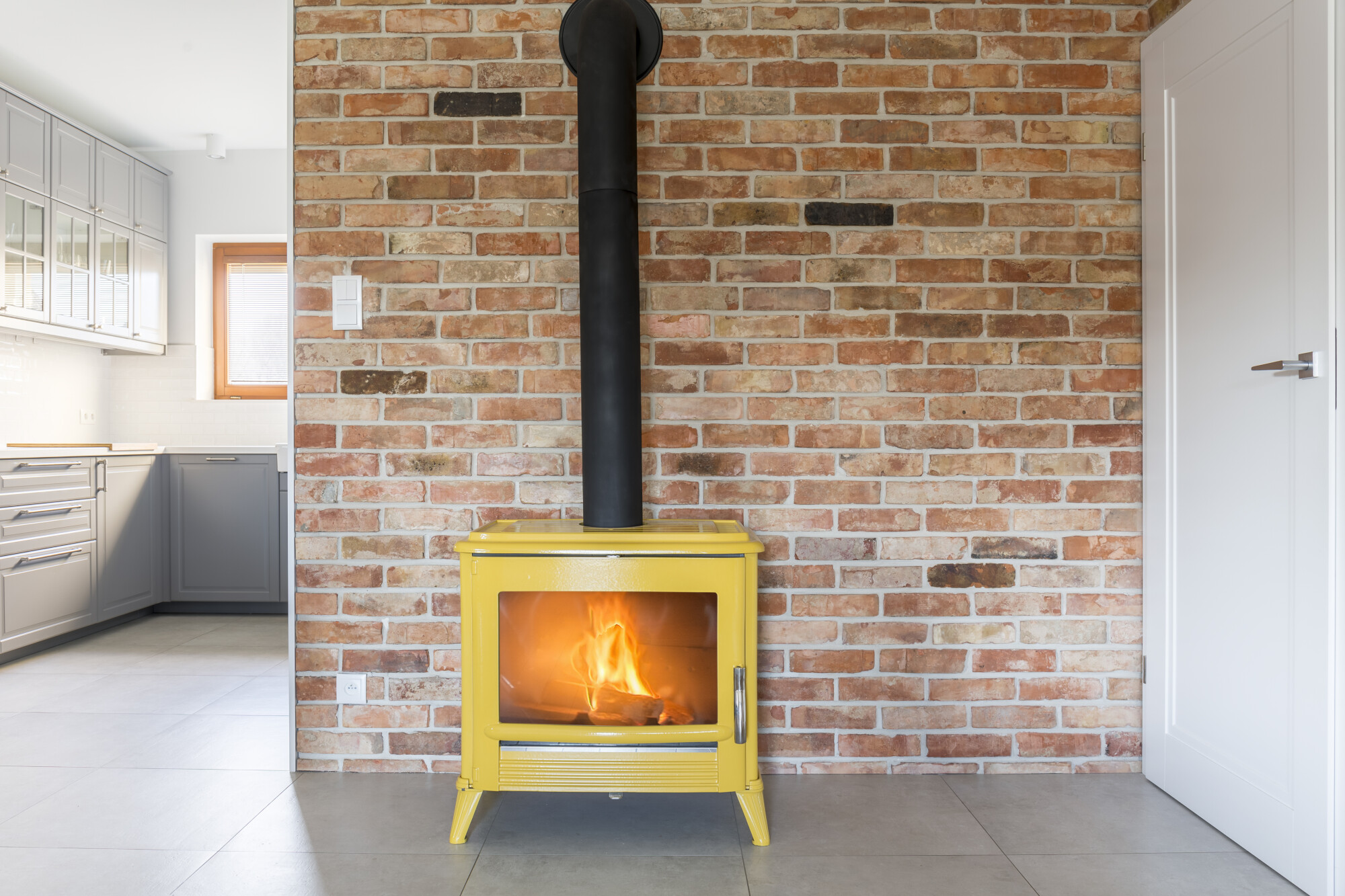 Loft,With,Red,Brick,Wall,And,Yellow,Freestanding,Stove