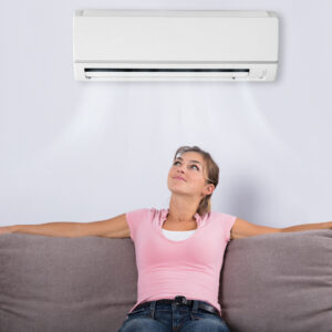 Woman Relaxing Under The Air Conditioner