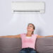 Woman Relaxing Under The Air Conditioner