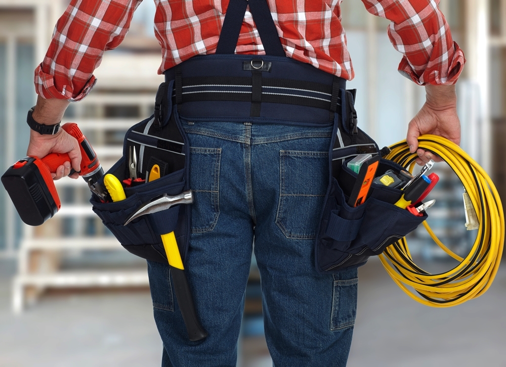 Electrician man with drill and wire cable.