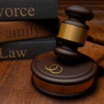 Gavel, divorce law books and wedding rings