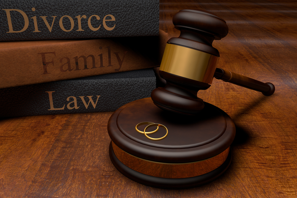 Gavel, divorce law books and wedding rings