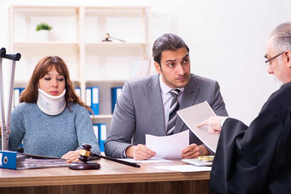 Young,Woman,In,Courthouse,With,Judge,And,Lawyer